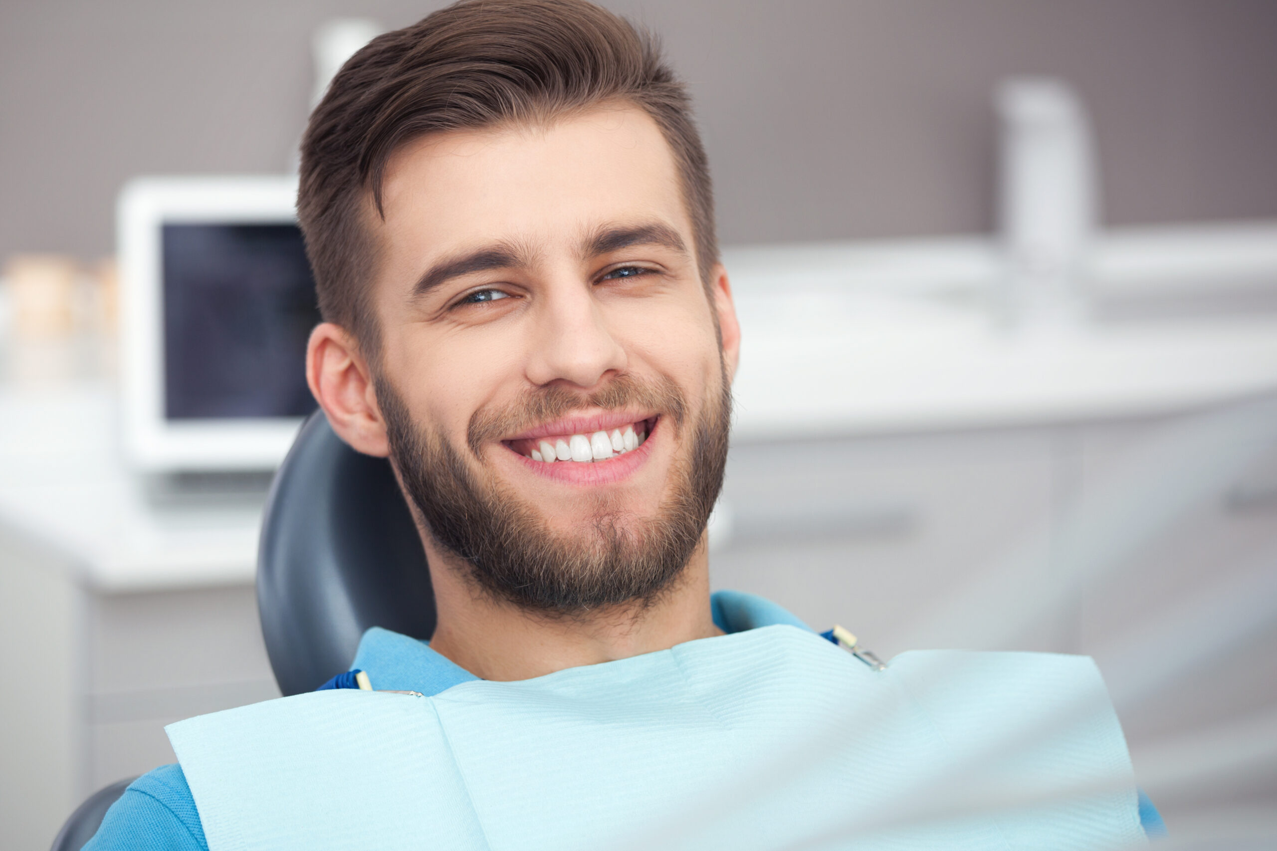 My smile is perfect! Portrait of happy patient in dental chair.