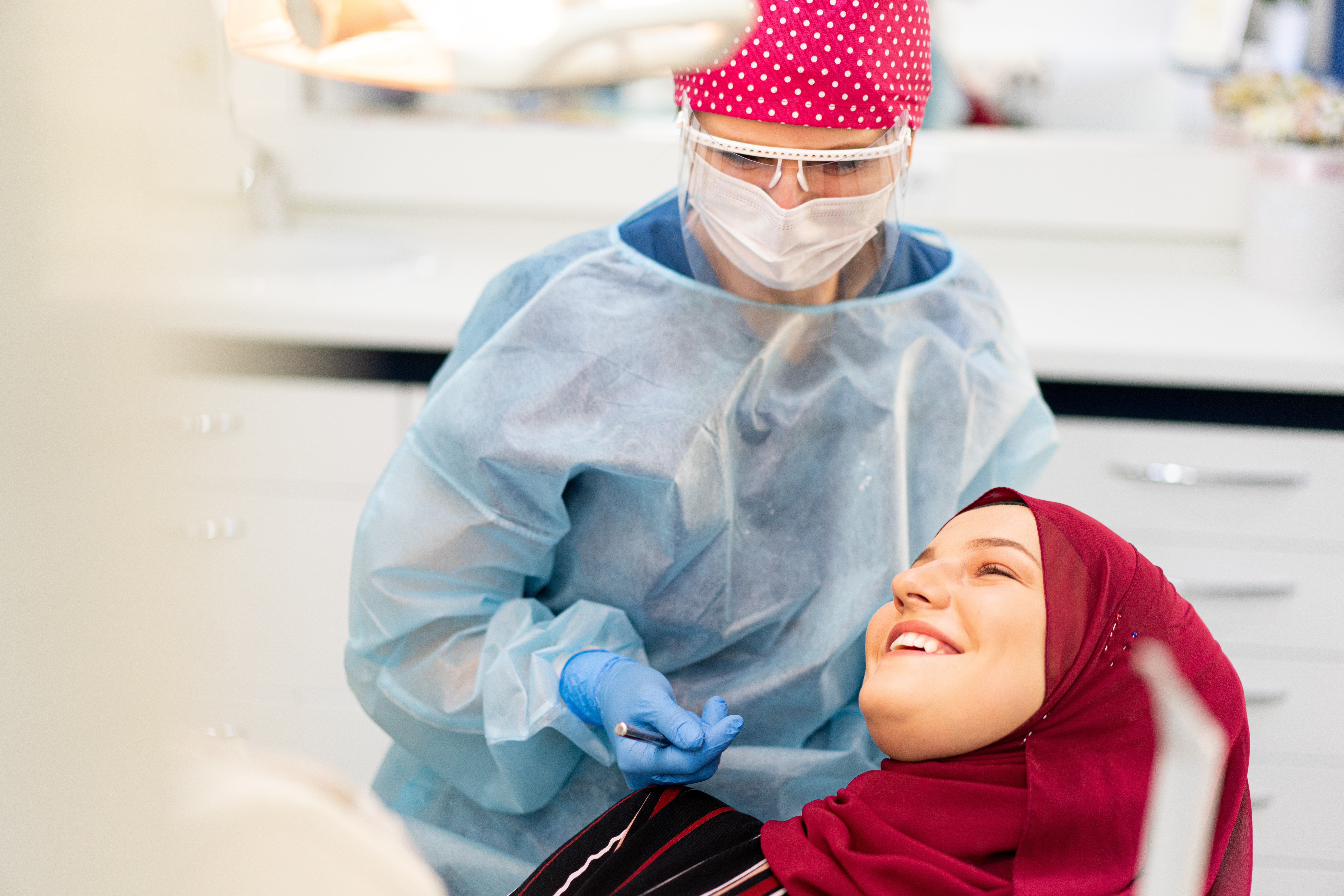 Muslim Middle Eastern girl inside dentist office. high quality photo