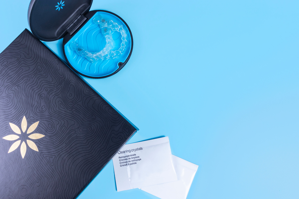 Invisible transparent aligners invisalign blue package with a box, clear-plastic retainers and cleaning crystals. With copyspace for banners and websites