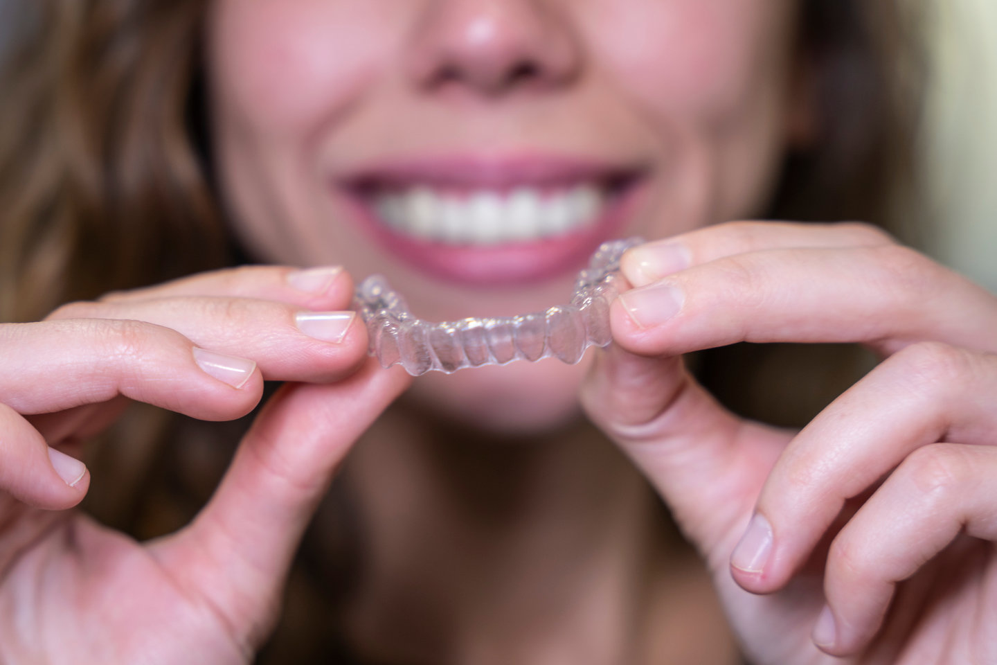 Young woman smiling showing her invisible ortodonthics